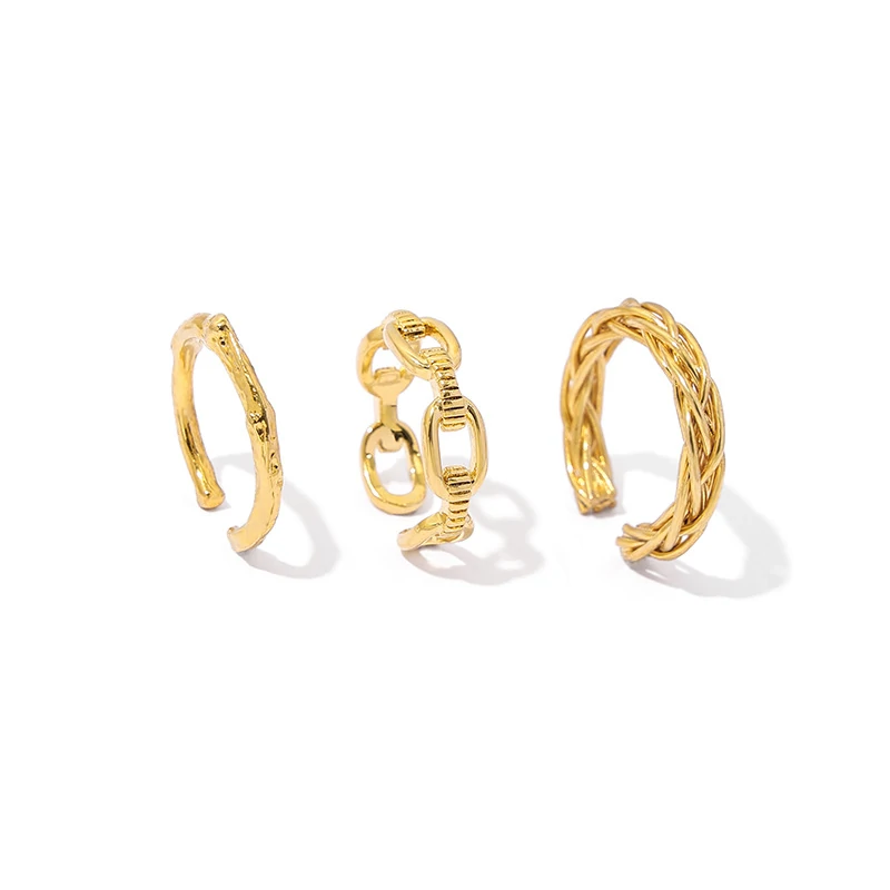Stacked LIVKE braided and chain rings on hand with bohemian embroidery sleeve, showcasing boho-chic layering.