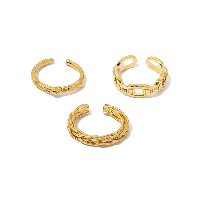 Stacked LIVKE braided and chain rings on hand with bohemian embroidery sleeve, showcasing boho-chic layering.