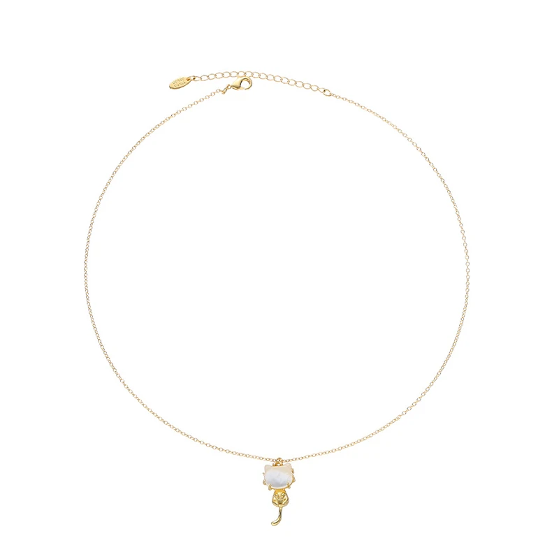 Woman wearing LIVKE cat and shell necklace walking with cat on sunset beach, symbolizing pet love and coastal aesthetic jewelry