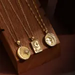 Celestial Charm Necklace Set 6 Gold sun and moon pendants layered on model with white linen shirt