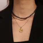 Celestial Charm Necklace Set 2 Gold sun and moon pendants layered on model with white linen shirt