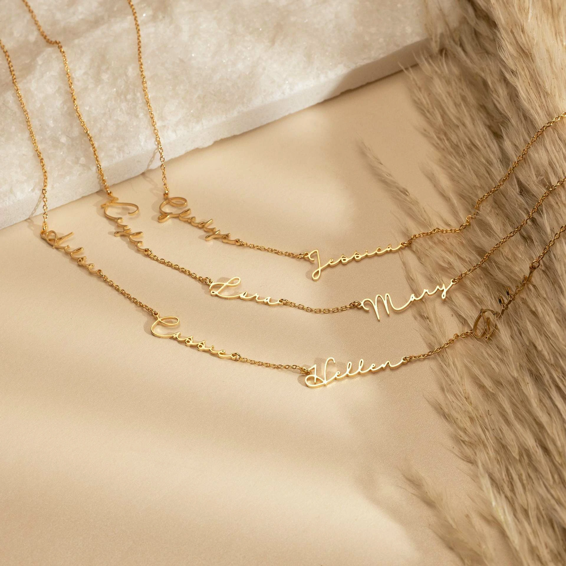 livke-custom-name-necklace-30-fonts (5) Gold name necklace with 'Believe' engraved in modern font on collarbone