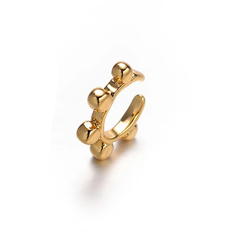 18K gold-plated adjustable heart ring with brilliant zirconia center, layered with minimalist bands on marble texture