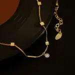 Professional woman wearing LIVKE square zirconia necklace with blazer and silk shirt, showcasing minimalist office jewelry for modern workwear