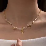 Young woman wearing LIVKE gold cross necklace with layered chains at music festival, blending spiritual jewelry with bohemian style