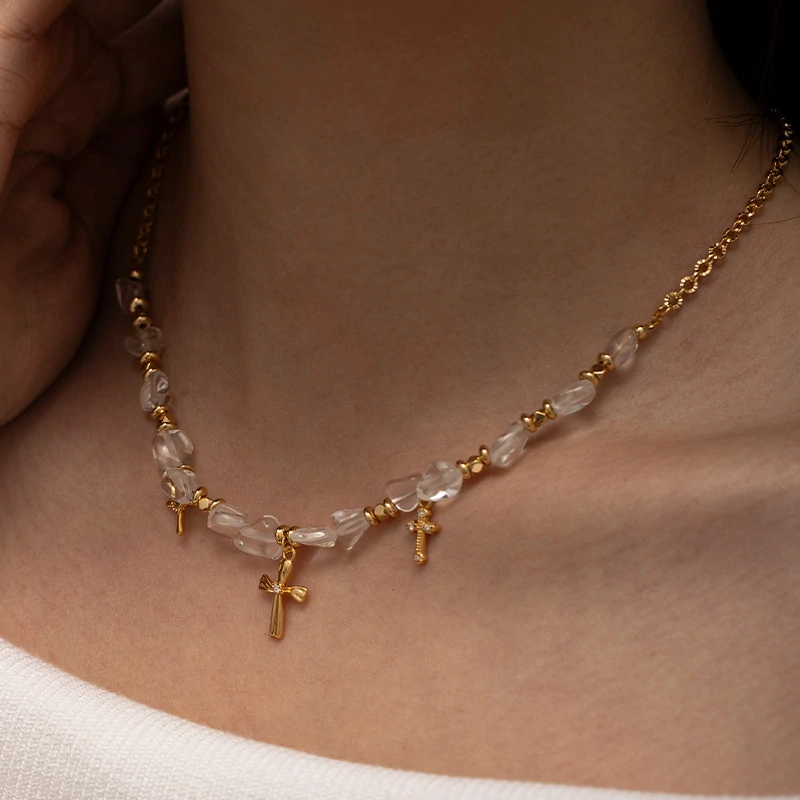 Young woman wearing LIVKE gold cross necklace with layered chains at music festival, blending spiritual jewelry with bohemian style