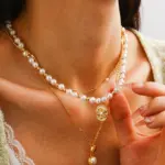 Gold Plated Brass Pearl Necklace 3 Woman wearing LIVKE gold plated pearl necklace with silk blouse and tailored blazer, showcasing vintage-inspired office to evening jewelry