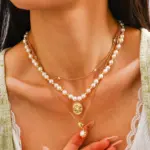 Gold Plated Brass Pearl Necklace 2 Woman wearing LIVKE gold plated pearl necklace with silk blouse and tailored blazer, showcasing vintage-inspired office to evening jewelry