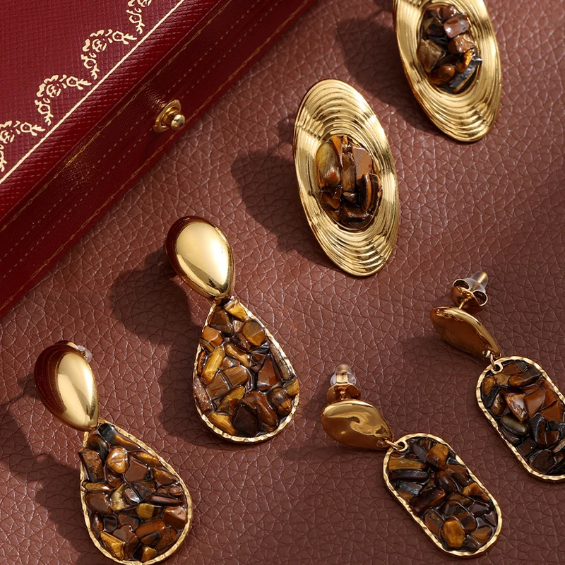 Woman wearing LIVKE teardrop tiger eye earrings with tailored blazer, showcasing minimalist office jewelry with natural stone accents