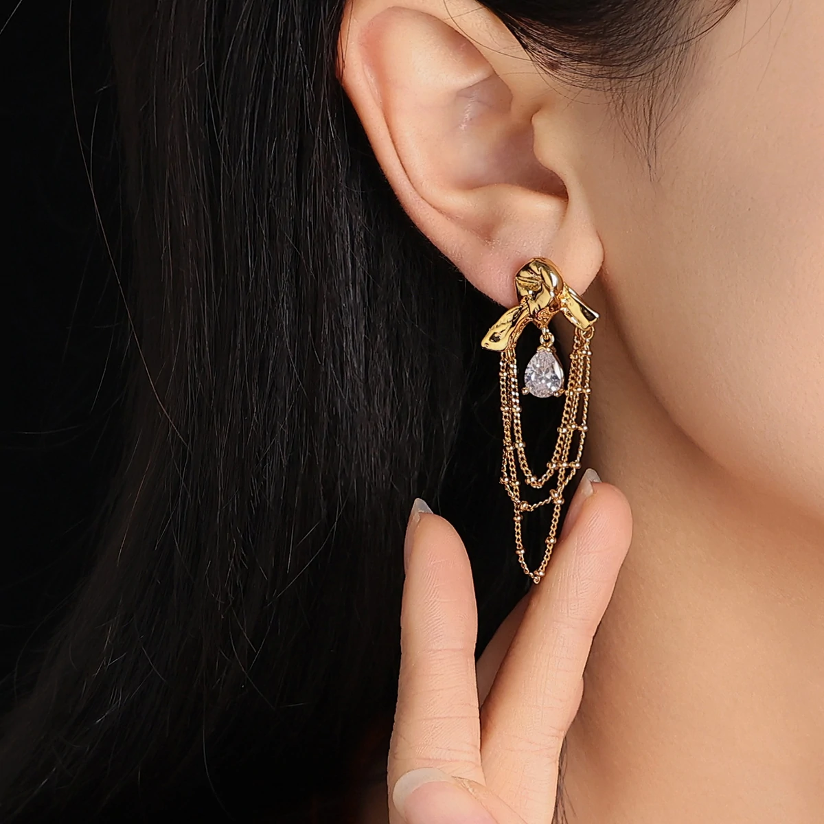 livke-knot-drop-cz-earrings-party (4) Gold knotted earrings with rainbow tassels on model dancing under club lights