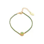 Adjustable layered bracelet with green braided cord, gold bead chains, and olive stone pendant on linen fabric, showing hypoallergenic clasp and boho styling for daily wear