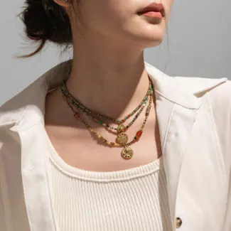 Woman wearing LIVKE cubic zirconia sweater necklace with knitwear and blazer, showcasing versatile minimalist jewelry for work and casual outfits