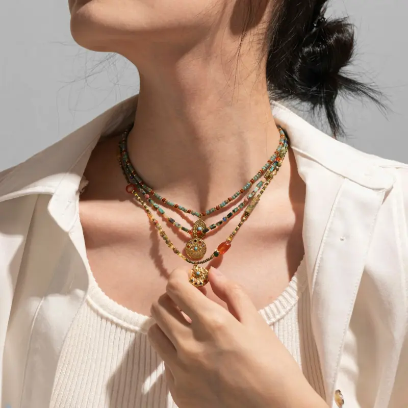 Woman wearing LIVKE cubic zirconia sweater necklace with knitwear and blazer, showcasing versatile minimalist jewelry for work and casual outfits