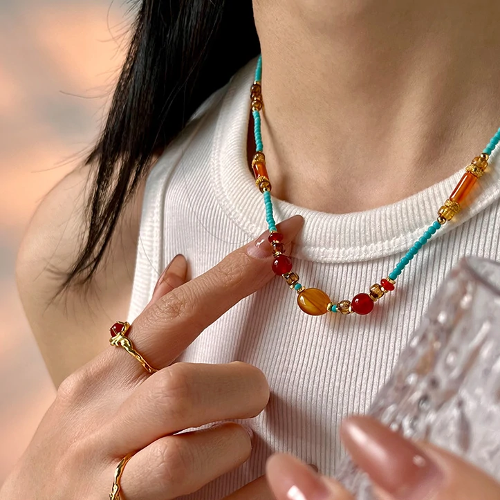 Asian model wearing LIVKE beaded necklace with cheongsam and tailored blazer, blending traditional Chinese elements with modern minimalist style
