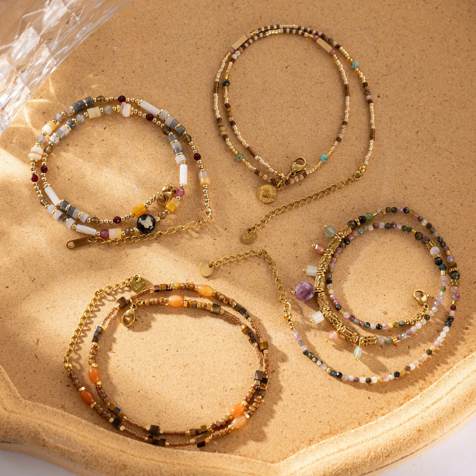 Woman wearing LIVKE multi-color stone necklace at desert festival, showcasing boho jewelry with adjustable gold pendant