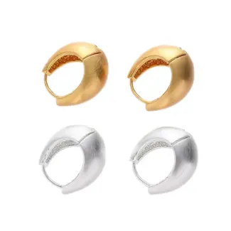 Architect wearing LIVKE gold orbital cuffs in minimalist gallery space, showcasing jewelry as wearable art