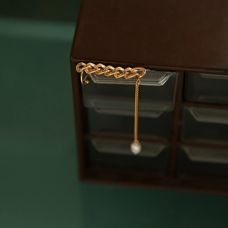 Model turning head to showcase flowing pearl tassels catching sunlight