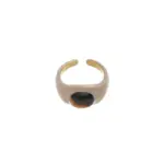 Hand wearing LIVKE adjustable tiger's eye ring layered with slim bands, showcasing bohemian power jewelry on desert-toned fabric