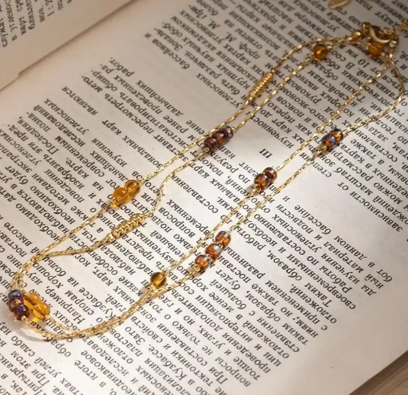 LIVKE gold-plated adjustable tri-bead necklace styled as double layers with minimalist pendants, showing day-to-night versatility