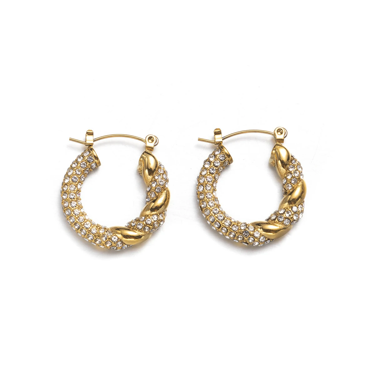 Gold twisted hoop earrings catching sunlight with layered necklaces on tanned skin