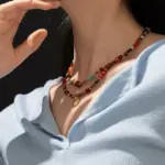 LIVKE surgical steel necklace with red agate and turquoise beads, layered with minimalist chains for boho-chic styling