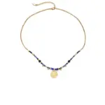 LIVKE’s gold-plated brass necklace featuring a lapis lazuli pendant, styled with a white linen blouse for effortless elegance.
