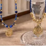 LIVKE’s gold-plated brass necklace featuring a lapis lazuli pendant, styled with a white linen blouse for effortless elegance.