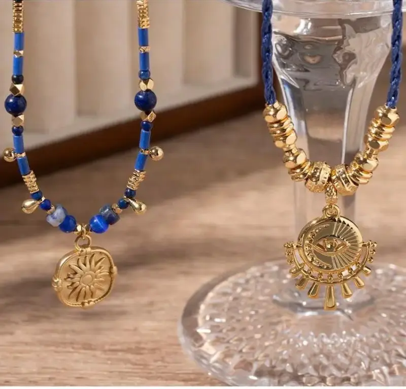 LIVKE’s gold-plated brass necklace featuring a lapis lazuli pendant, styled with a white linen blouse for effortless elegance.