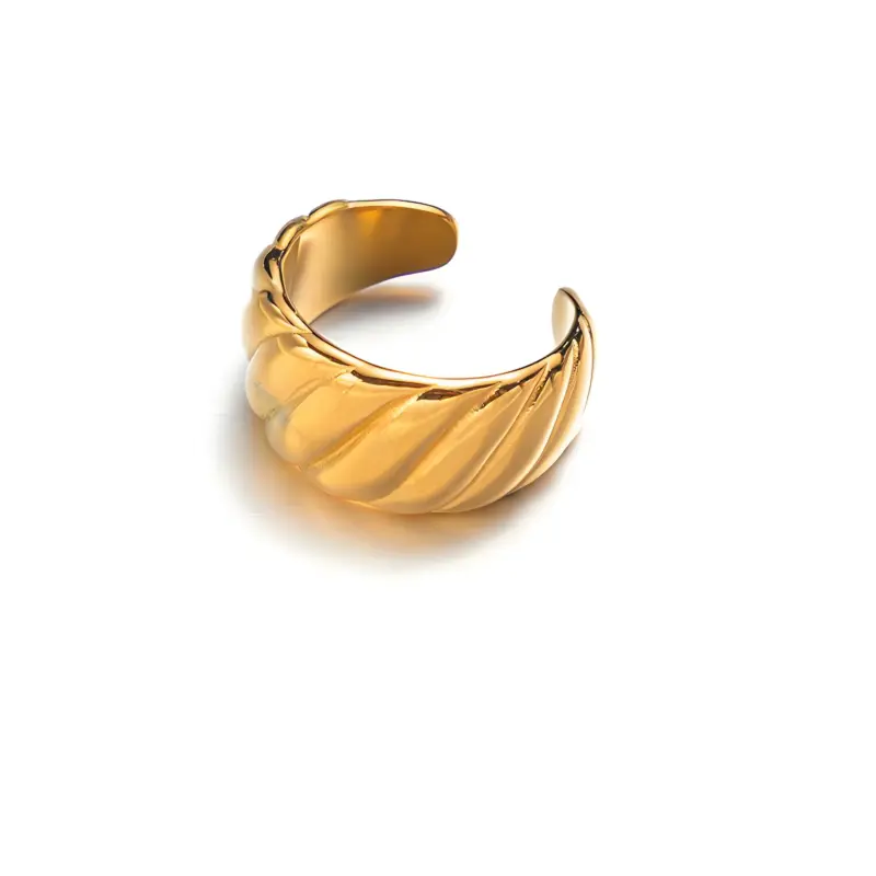Woman wearing LIVKE gold love signet ring while holding cappuccino in Parisian café, showcasing stackable jewelry styling