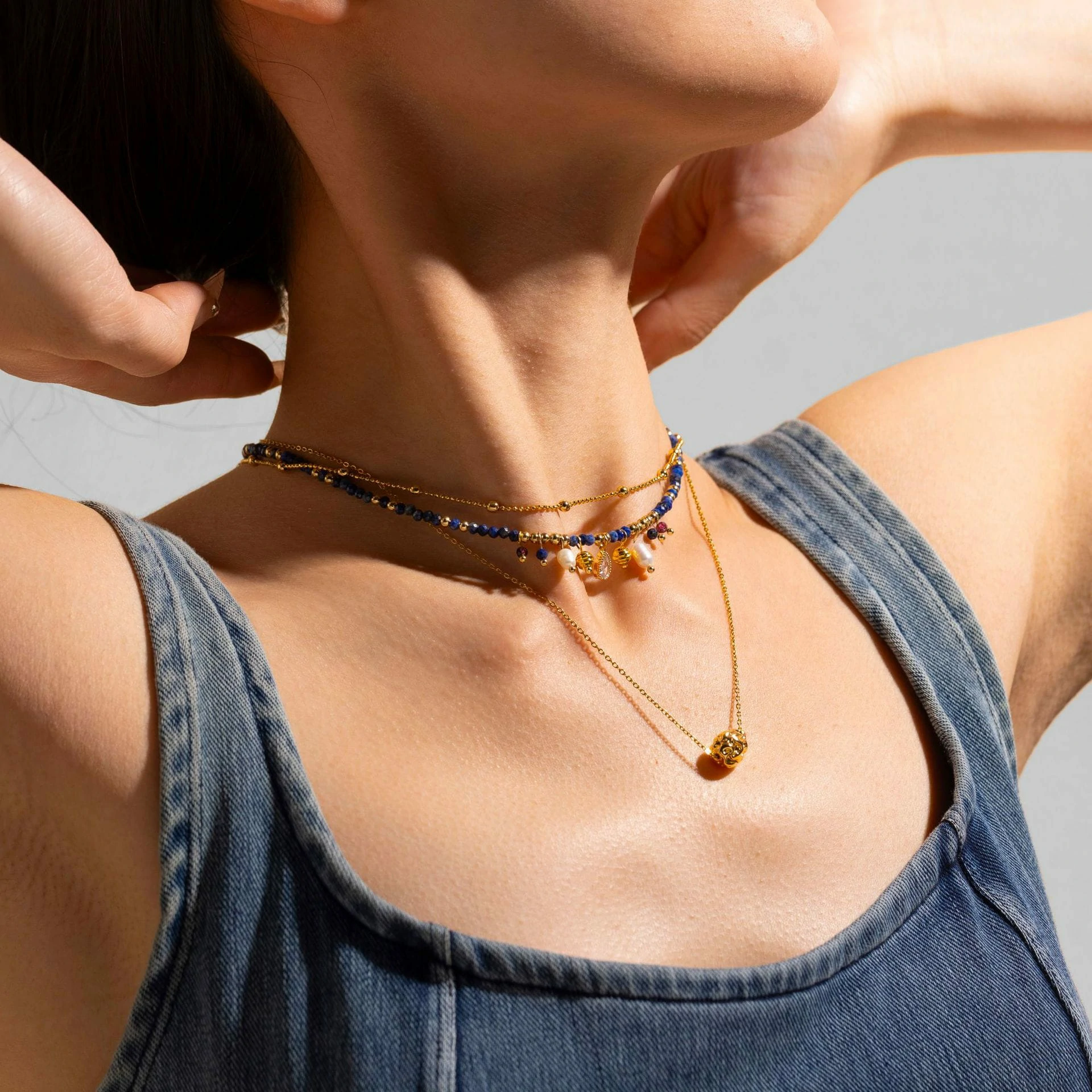 livke-vintage-pearl-layered-necklace-coastal-style (2) LIVKE 18K gold-plated layered necklace with colored pearls and zirconia, styled with linen and seashells for coastal minimalist aesthetic