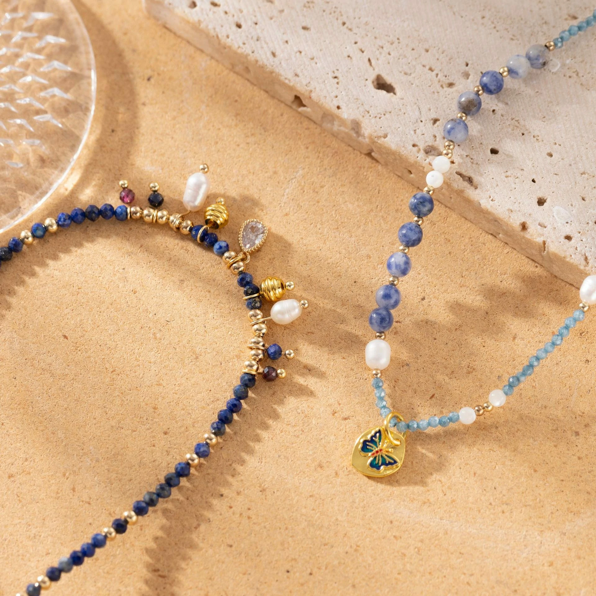 livke-vintage-pearl-layered-necklace-coastal-style LIVKE 18K gold-plated layered necklace with colored pearls and zirconia, styled with linen and seashells for coastal minimalist aesthetic